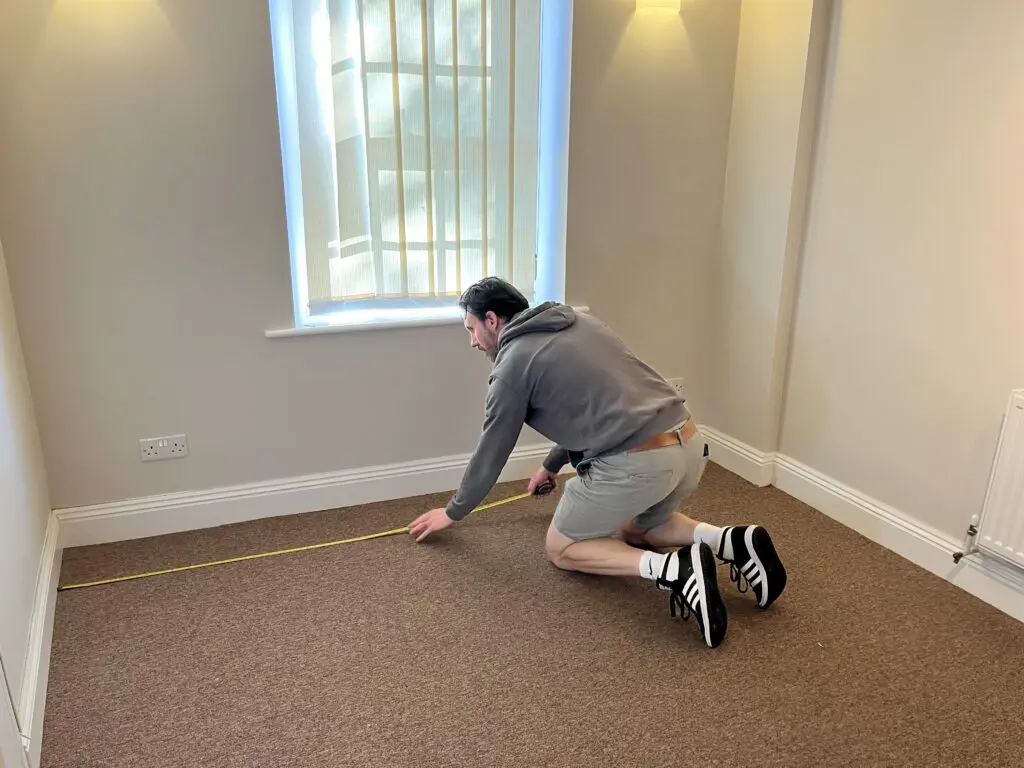 Photo of Chris measuring the Ready Steady Websites office in Romsey Hampshire