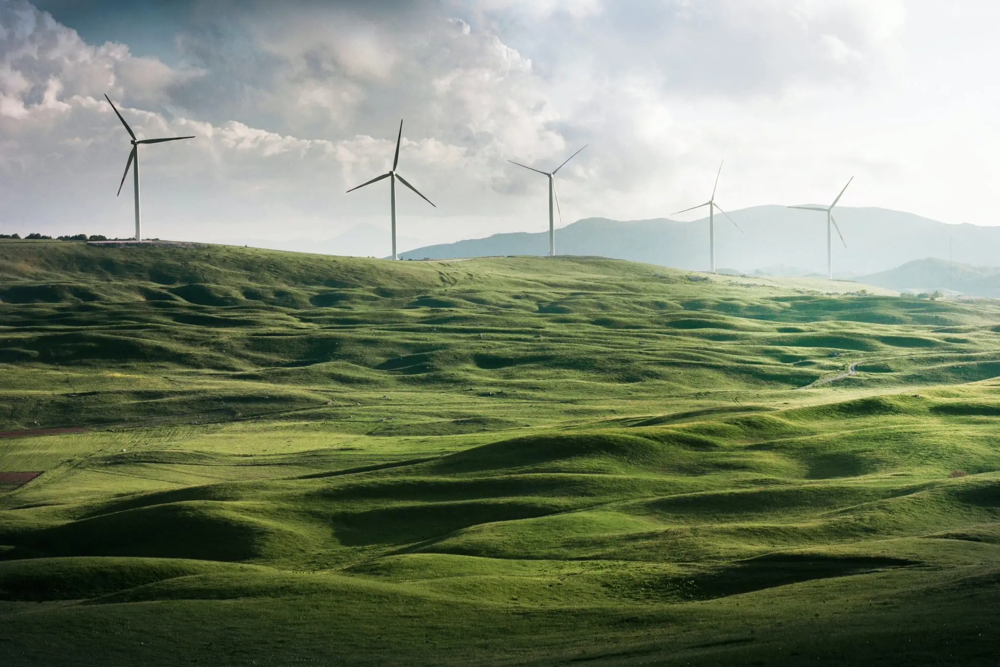 Wind turbines on a green hill