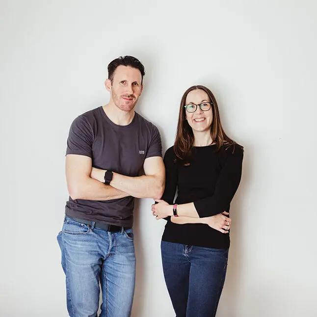 Chris and Jude Wharton standing up against a wall