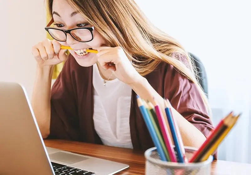 Woman biting pencil