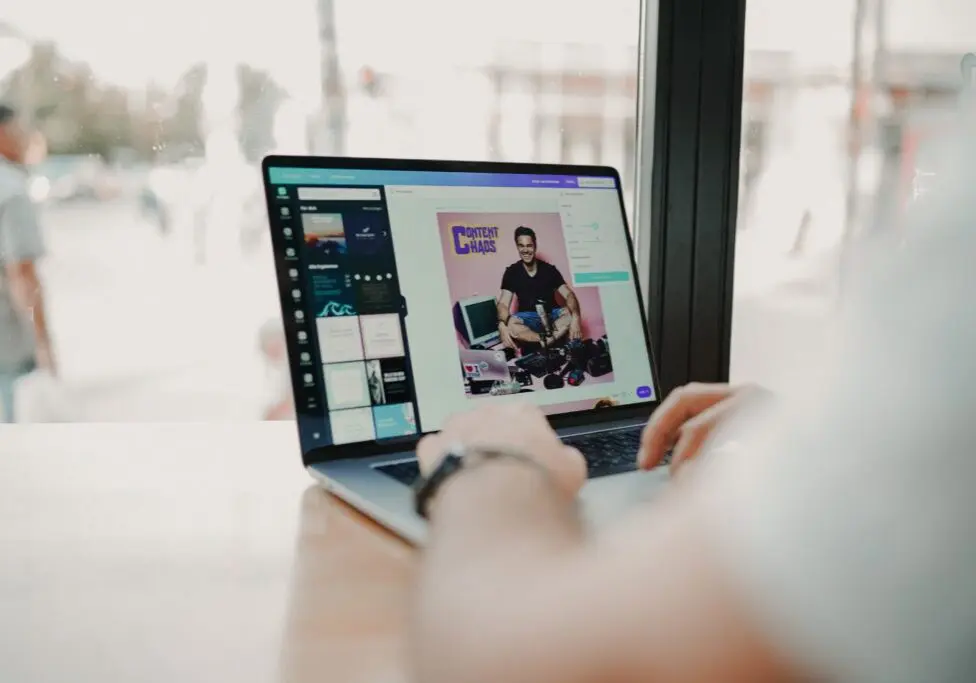 Someone creating image content on a laptop