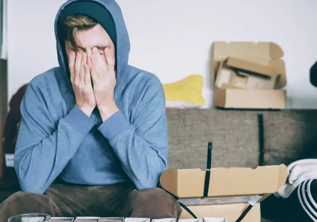 Man with face in hands at work