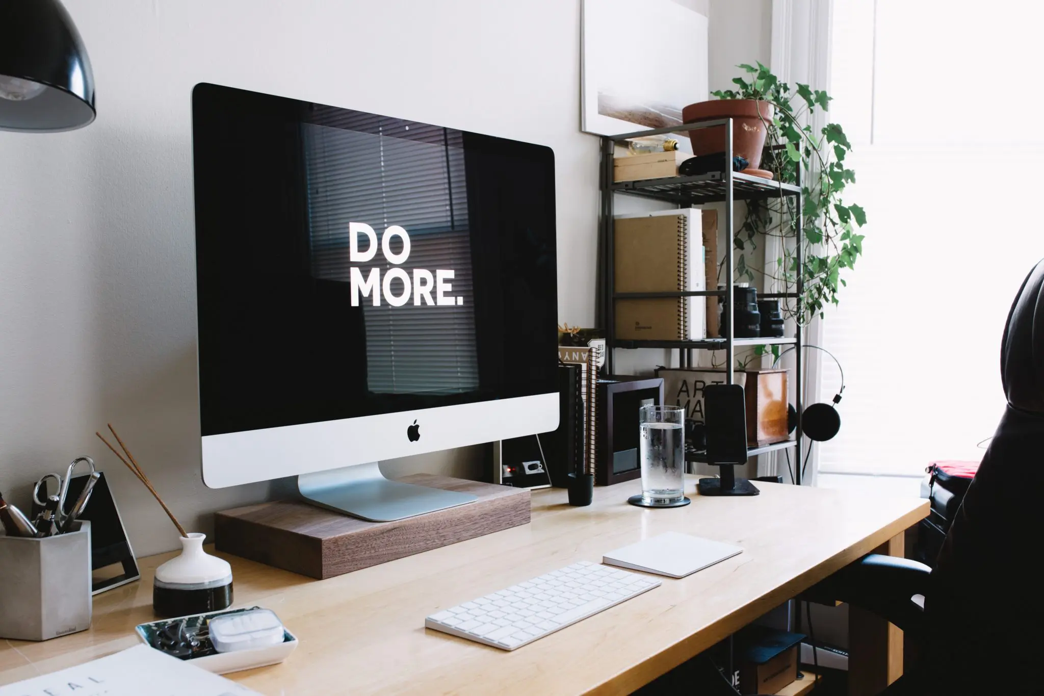 "Do more" shown on an iMac screen in a small home office