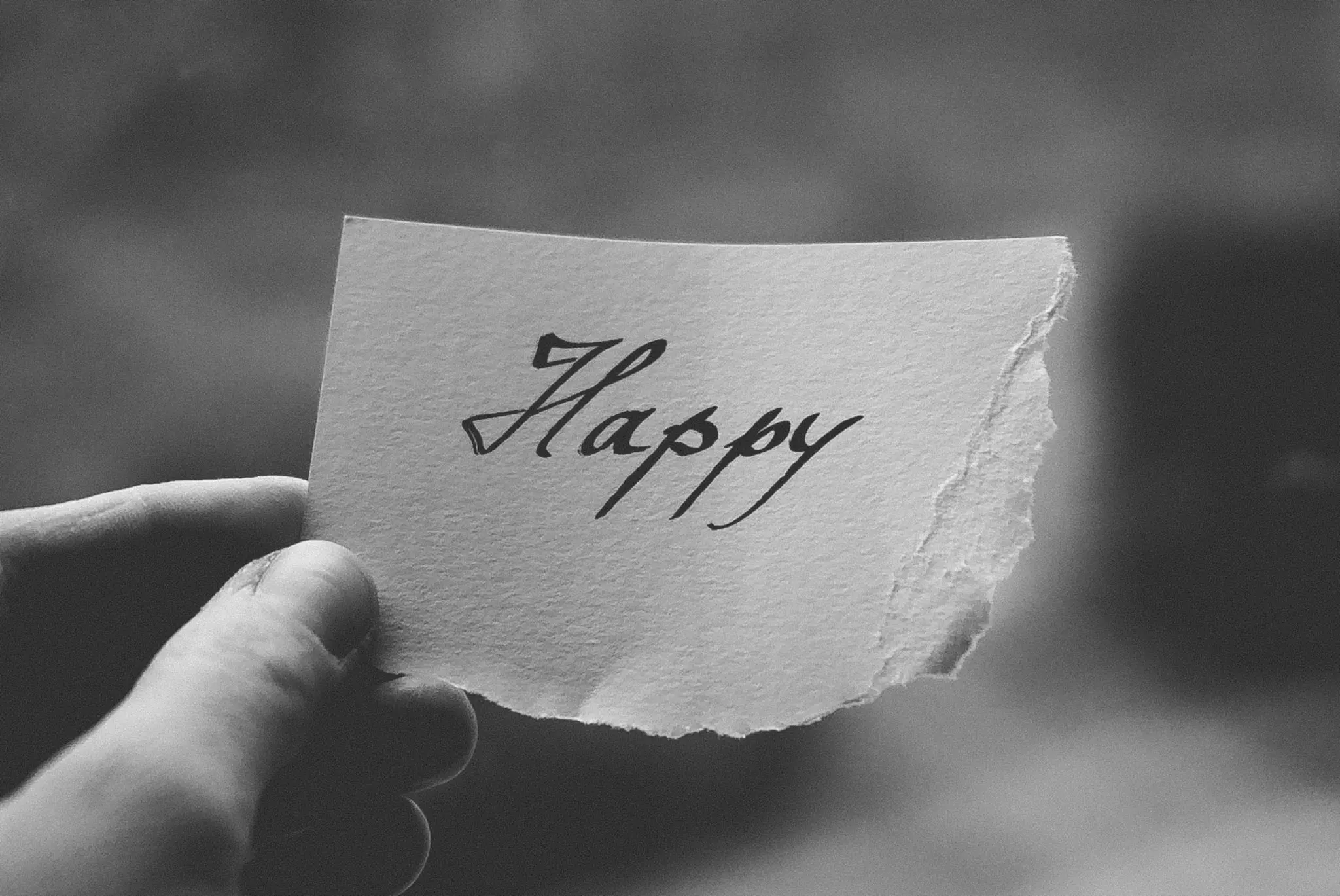Happy written on ripped paper