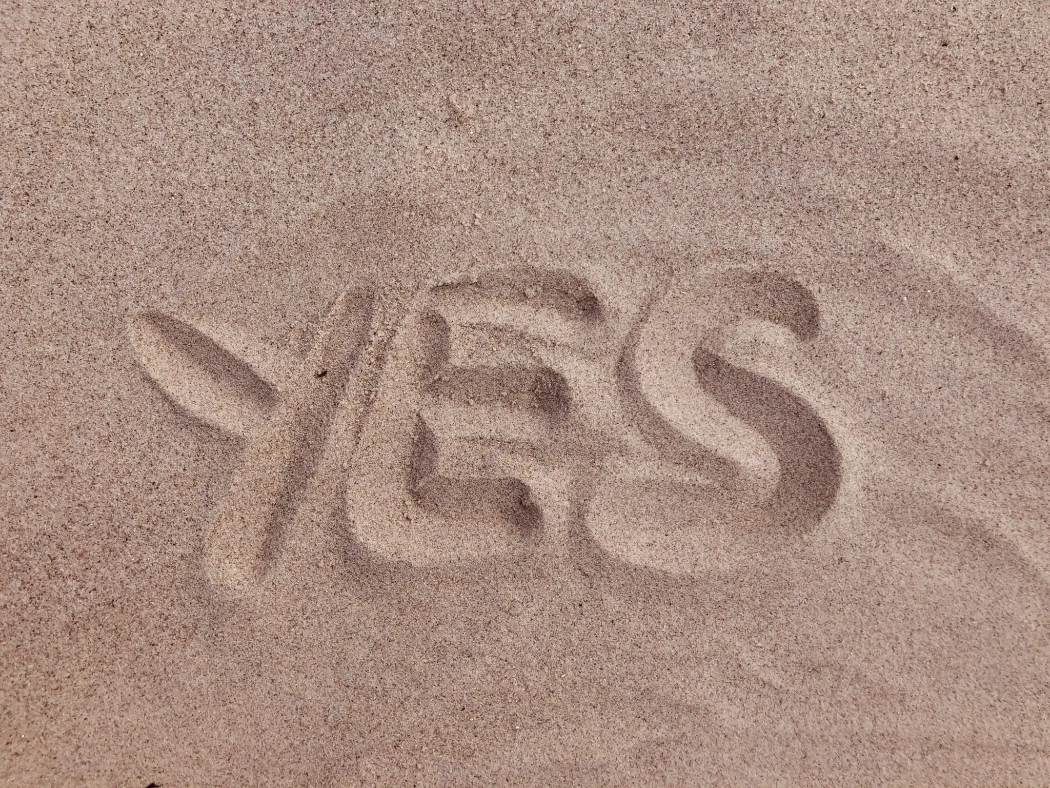 YES written in sand