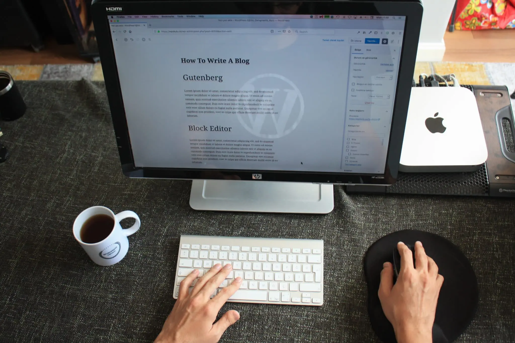 laptop with website content on next to a coffee cup