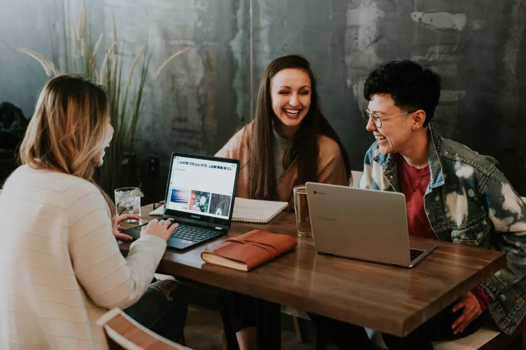 People smiling with laptops
