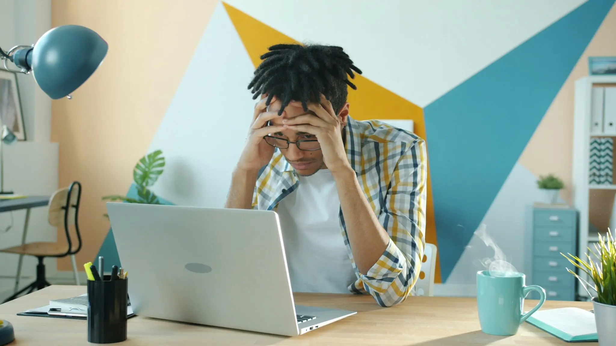 man frustrated at laptop