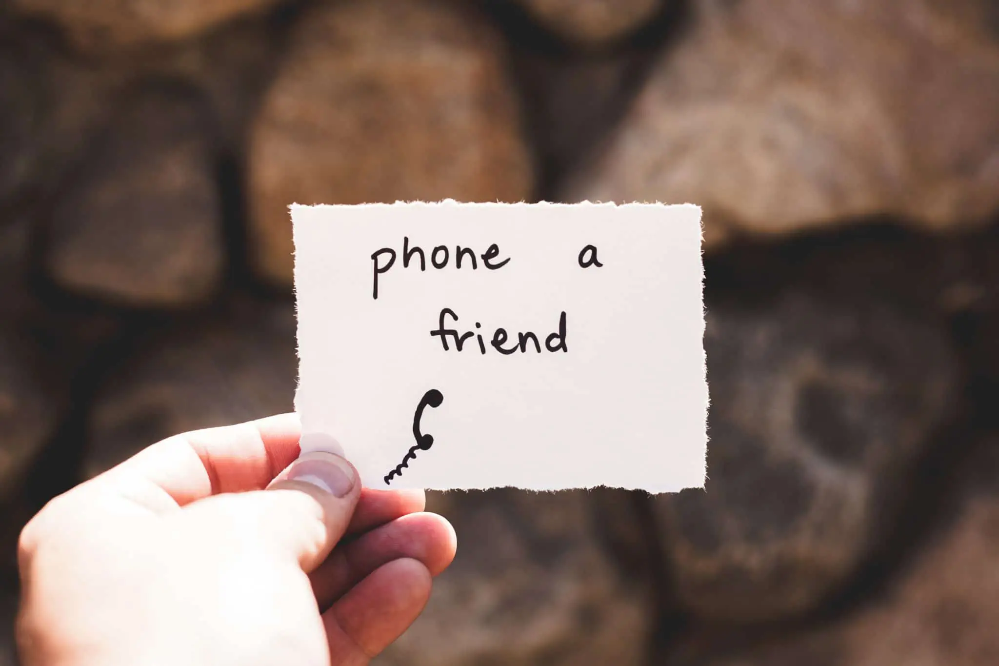 Piece of paper with phone and friend written on it so they stop getting overwhelmed