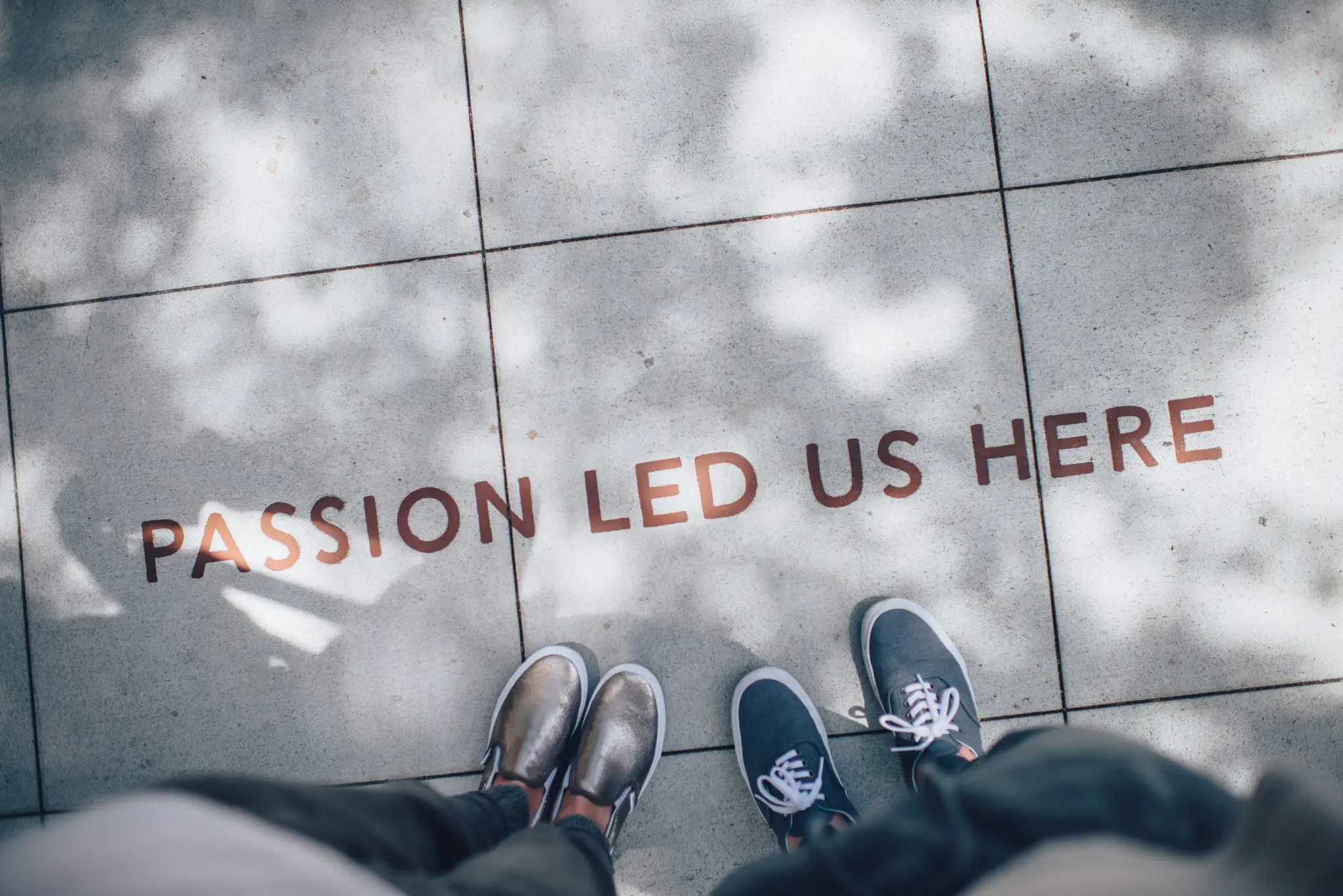 Pavement/Sidewalk with "Passion led us here" written on it