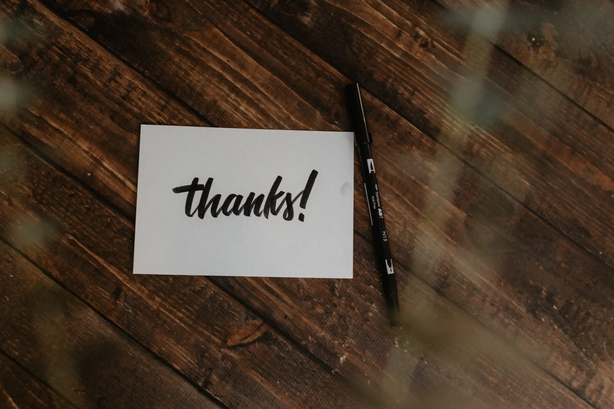 Thanks written on a postcard with pen