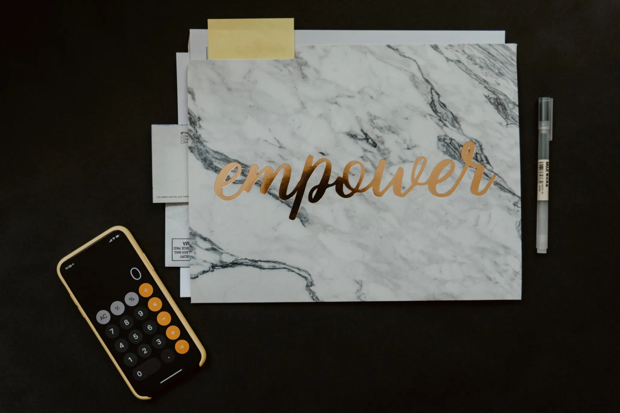 Calculator and notebook with "empower" written on it