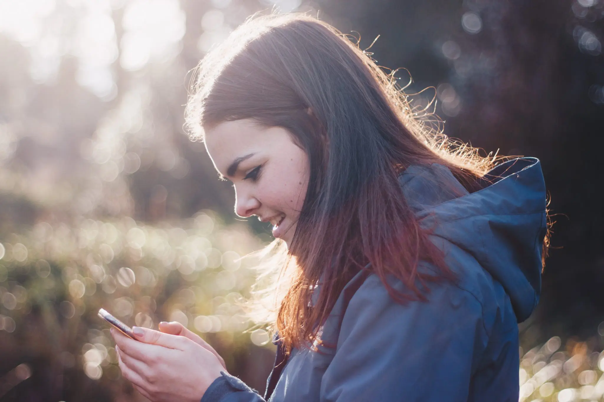 Woman outside checking phone