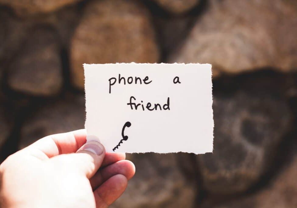 Piece of paper with phone and friend written on it so they stop getting overwhelmed