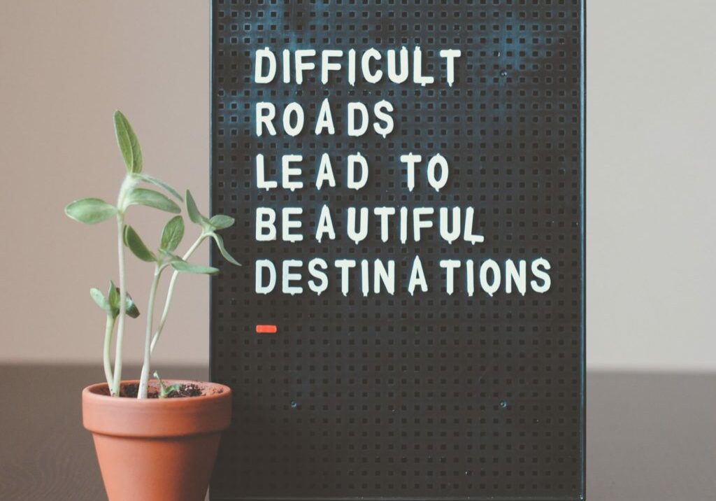 "Difficult roads lead to beautiful destinations" quote on board