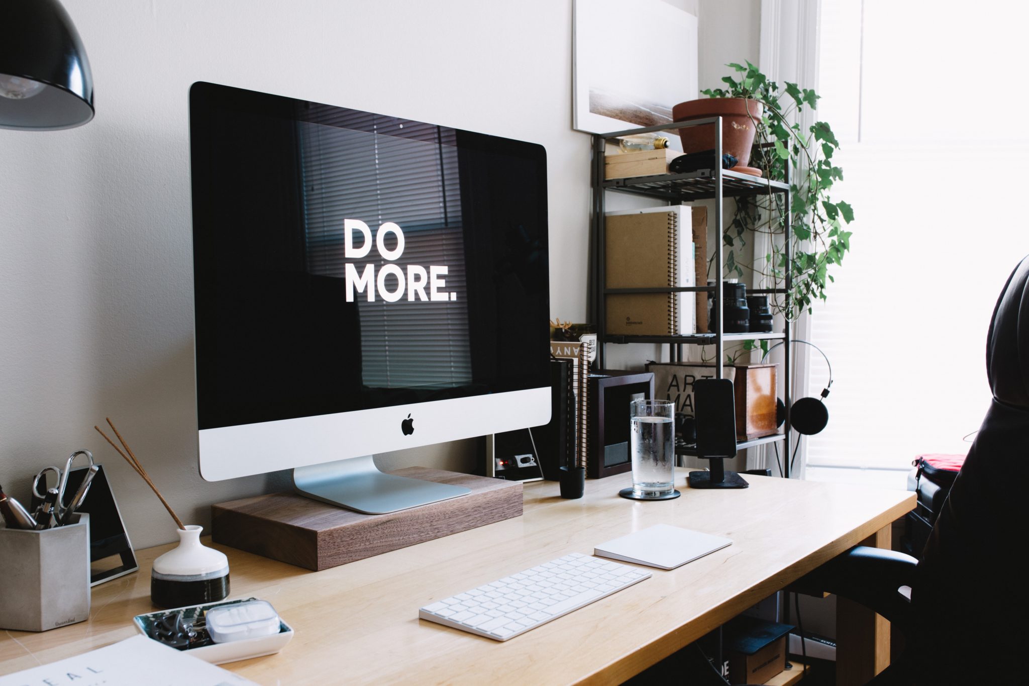 "Do more" shown on an iMac screen in a small home office