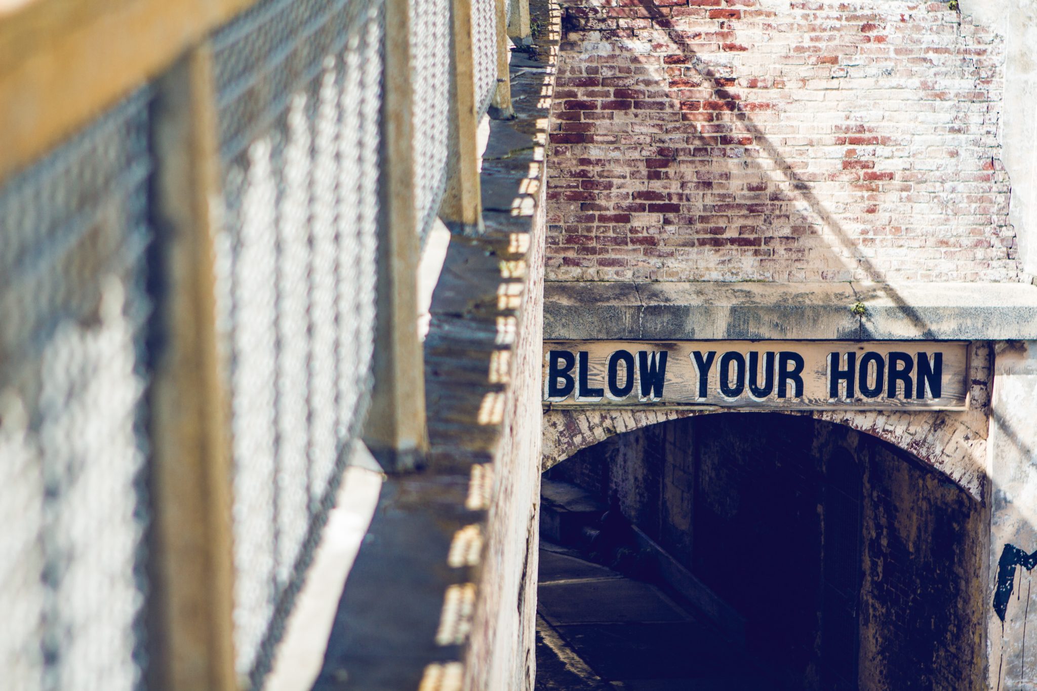 Tunnel with "Blow Your Horn" sign