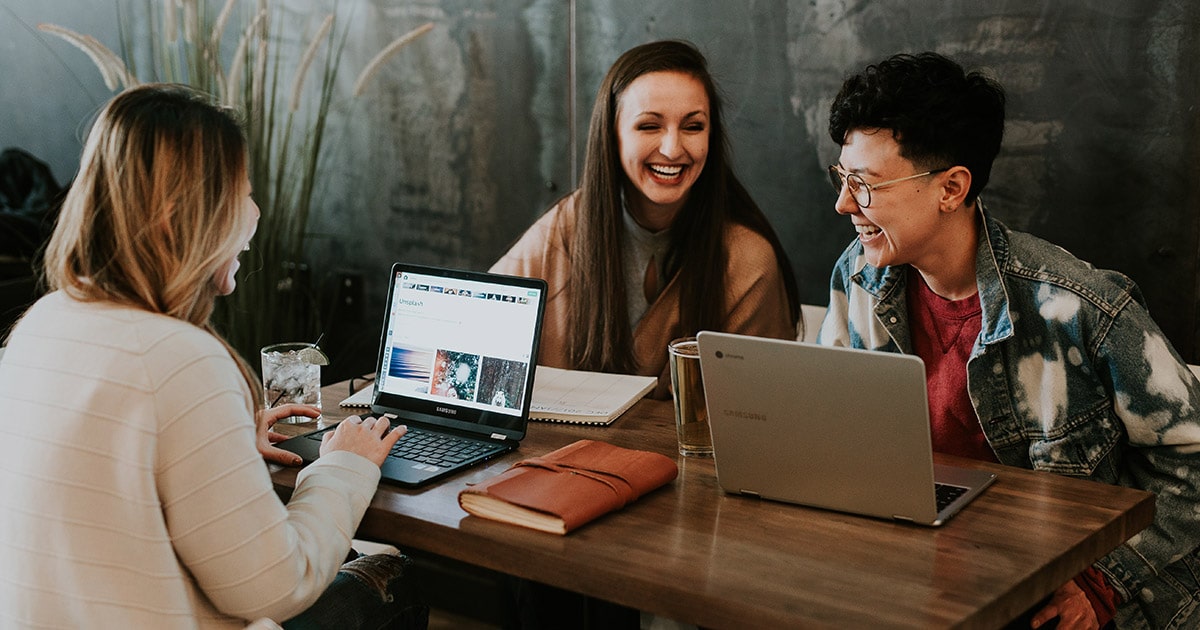 People smiling with laptops